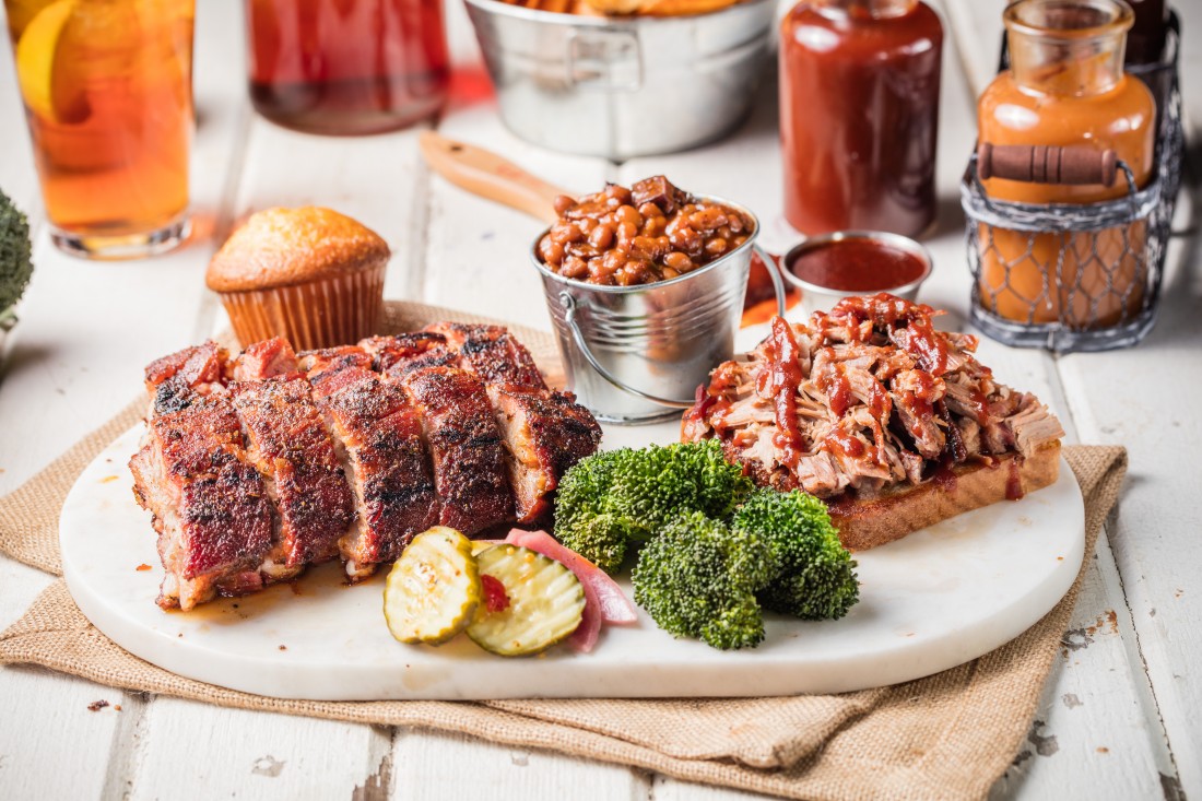 Famous Dave's BBQ Meat Combo with cornbread, a pail of baked beans, broccoli and pickles