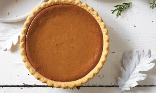 A whole, golden brown Pumpkin Pie