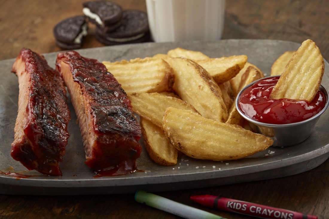 Smaller portion of BBQ Meat and potato wedges.