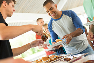 Man being given Famous Dave's BBQ Meat at a catering event