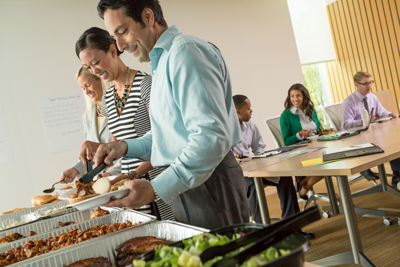 Corporate employees serving themselves Famous Dave's Cleveland catering buffet