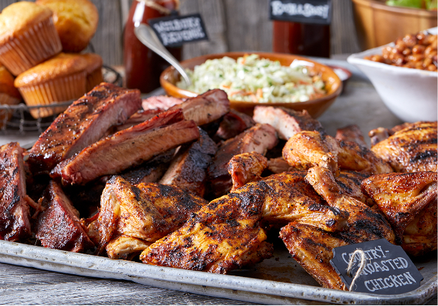 Family to go Famous Dave's BBQ Meat with lots of ribs, chicken, cornbread, and coleslaw