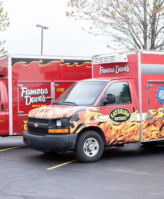 Famous Dave's Catering Trucks parked next to each other